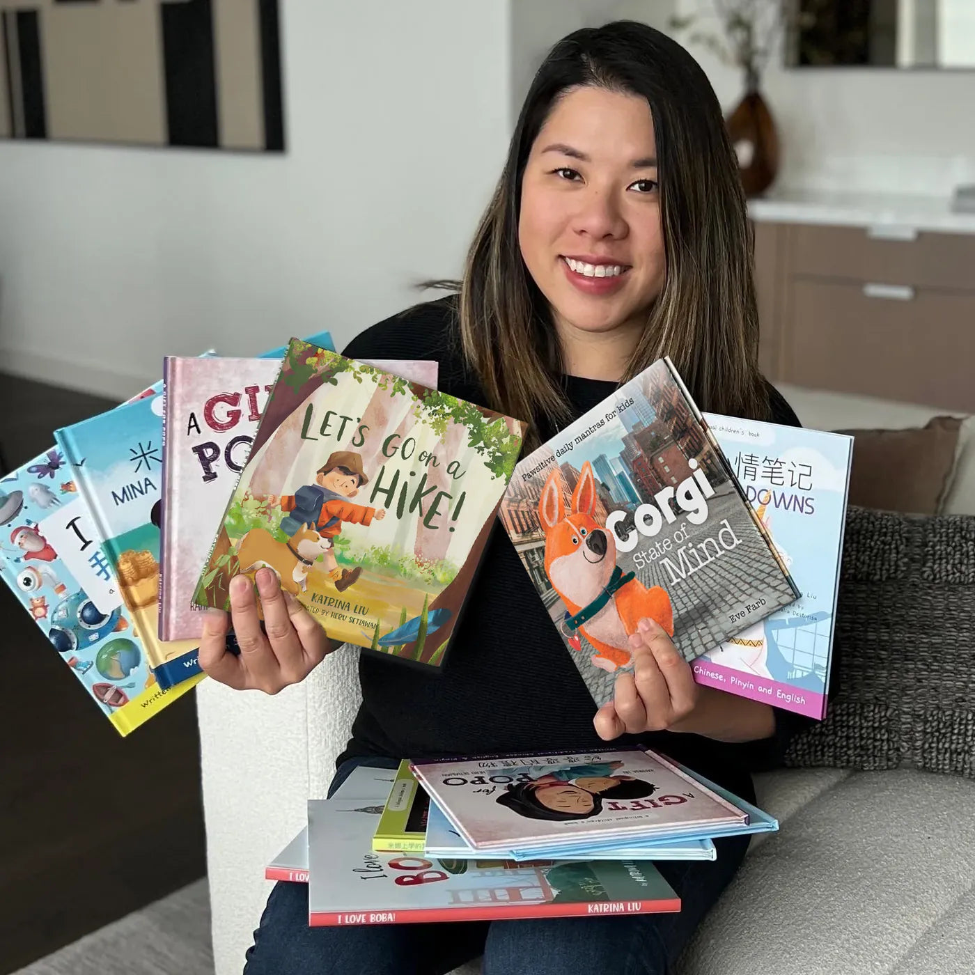 Katrina Liu holding her published children's books