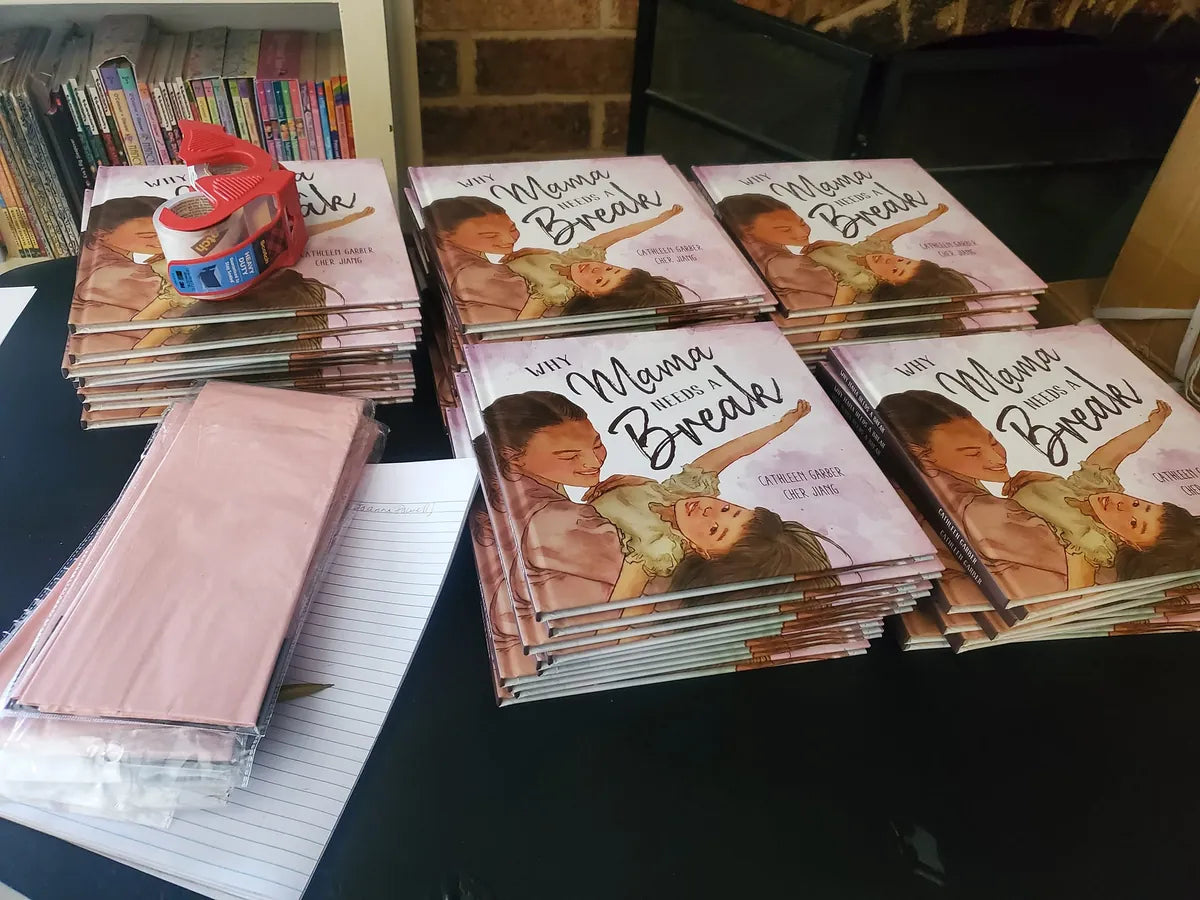 Stacks of Why Mama Needs a Break by Cathleen Garber, packed for shipping