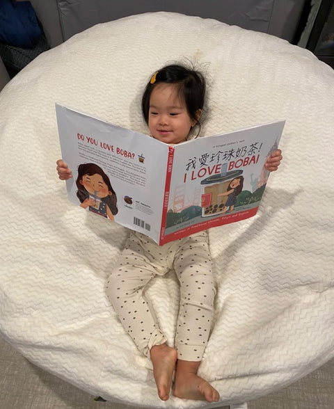 A family reading a Lychee Press book