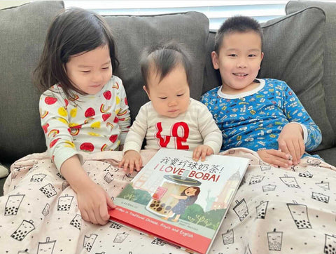 A family reading a Lychee Press book