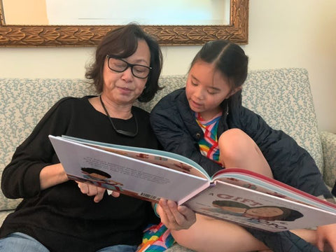 A family reading a Lychee Press book