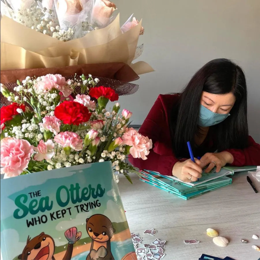Joan Bang signing copies of her book, The Sea Otters Who Kept Trying