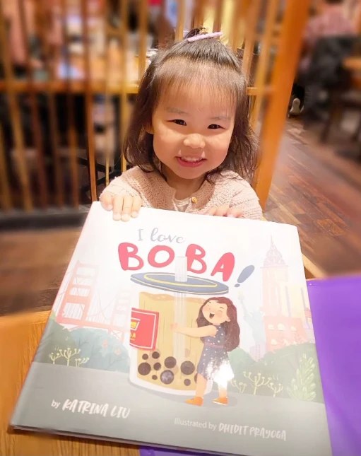 A family reading a Lychee Press book